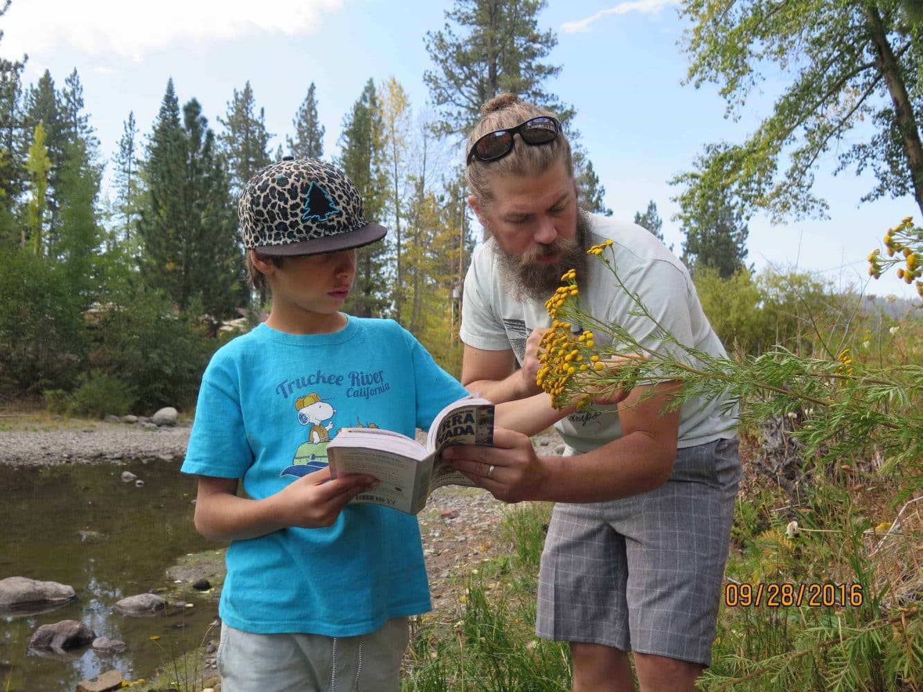 4th grader with his teacher at the truckee river