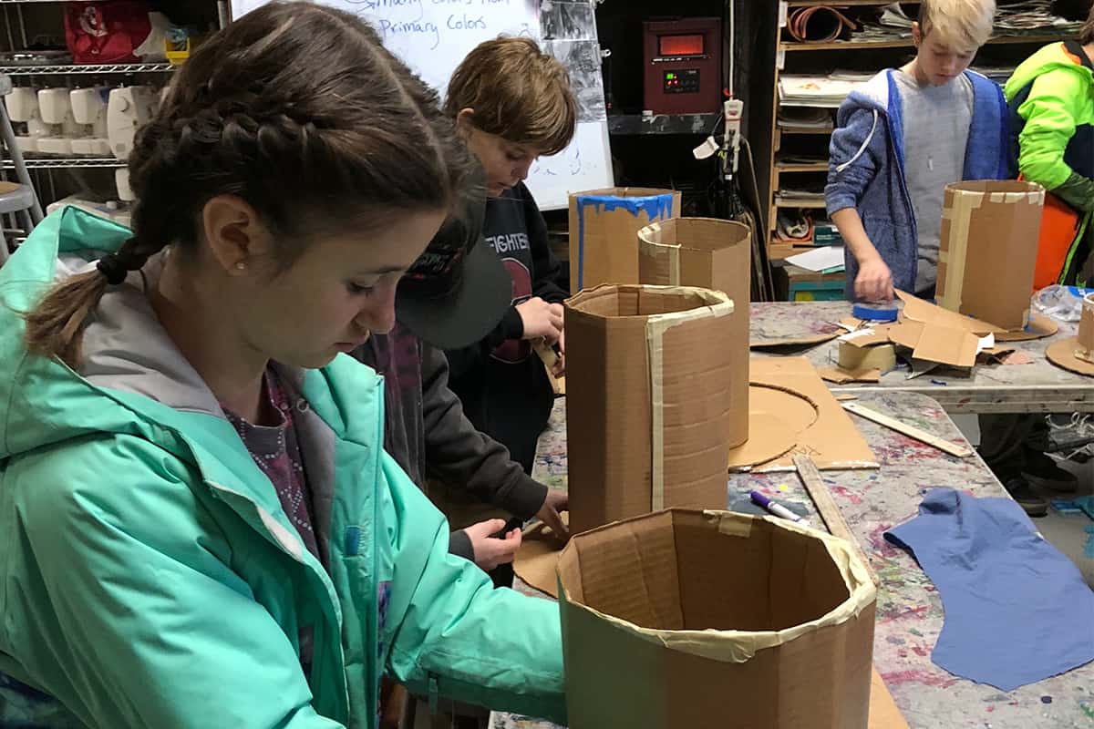 art students making cardboard hats