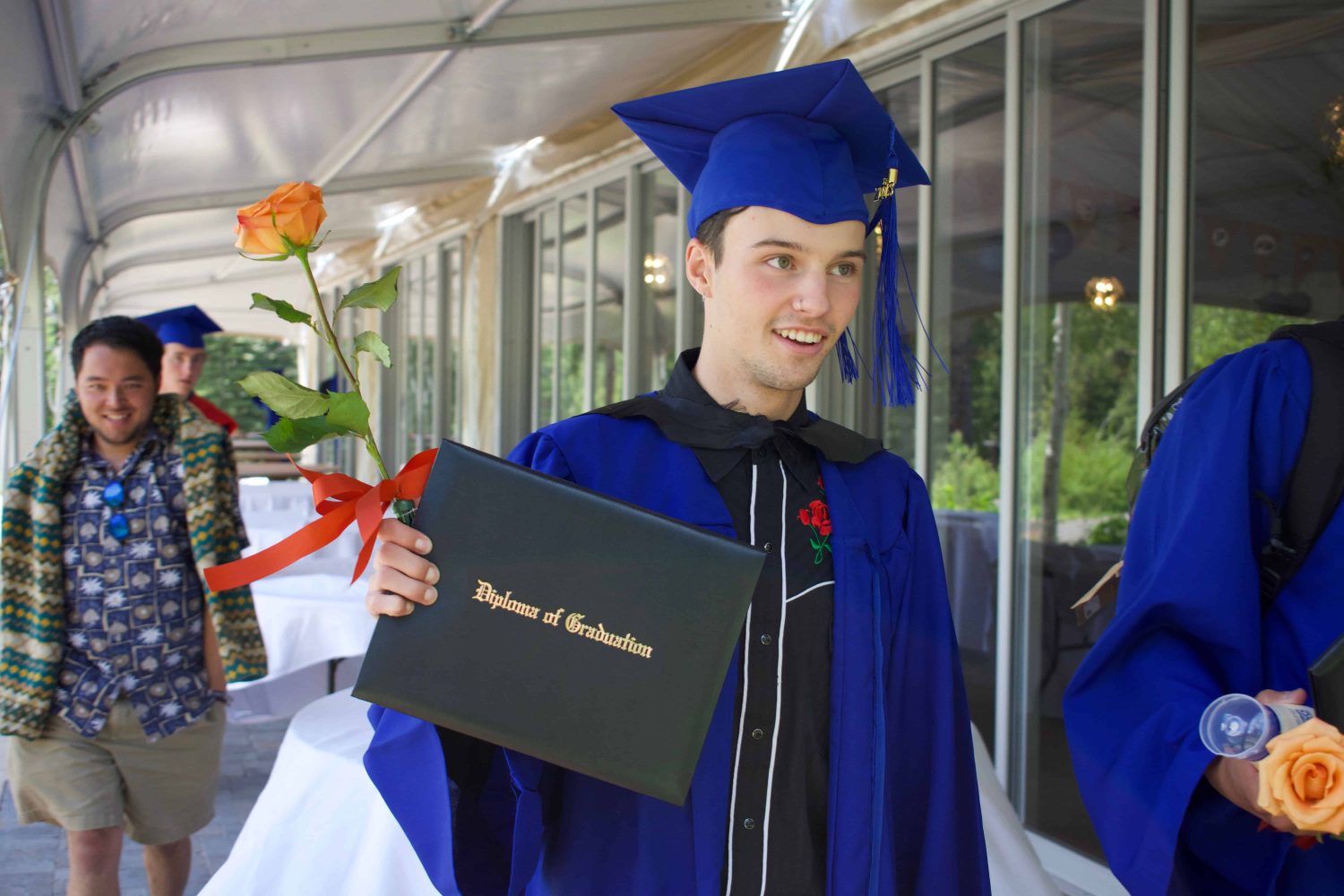 a graduate showing his diploma