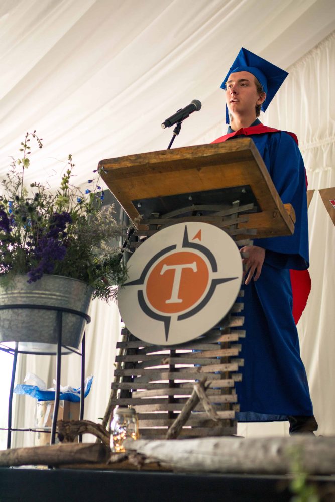 a graduate speaking from a podium