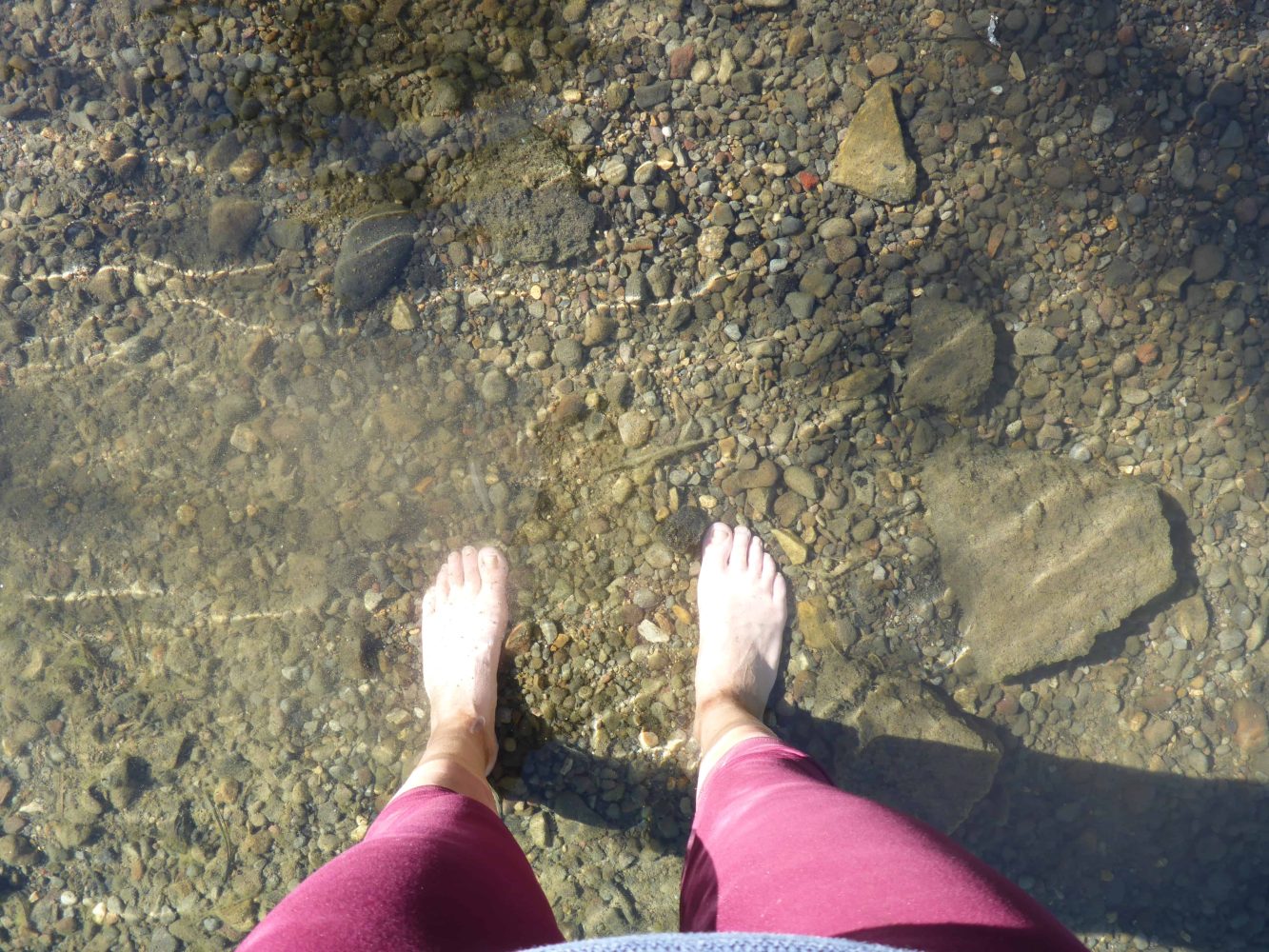 student standing in shallow water