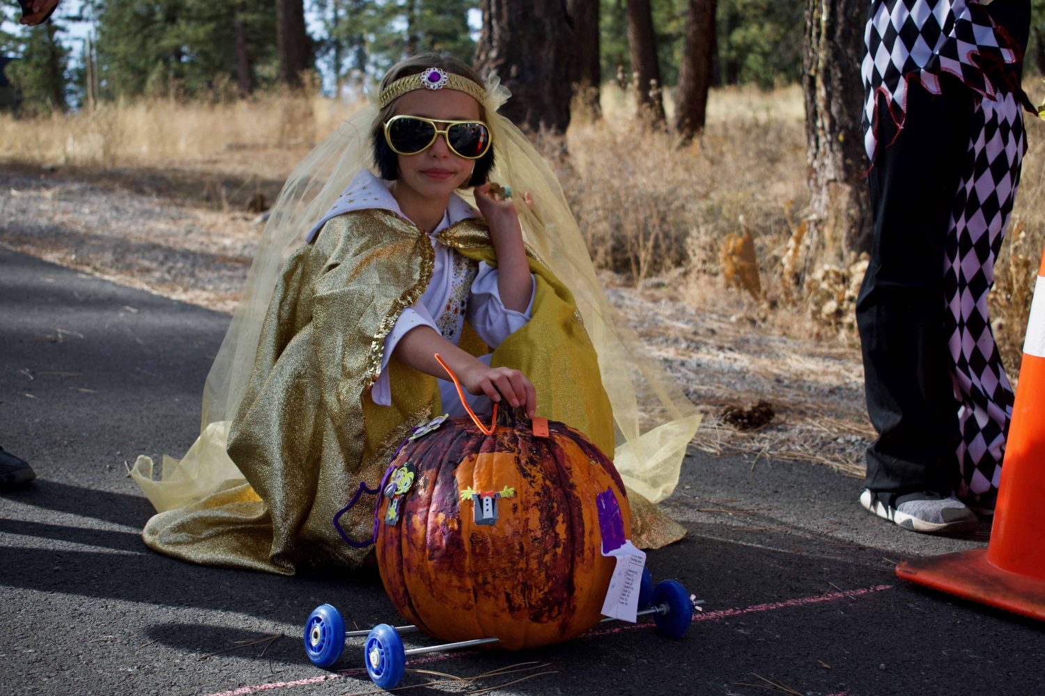 a student with her pumpkin car at the starting line