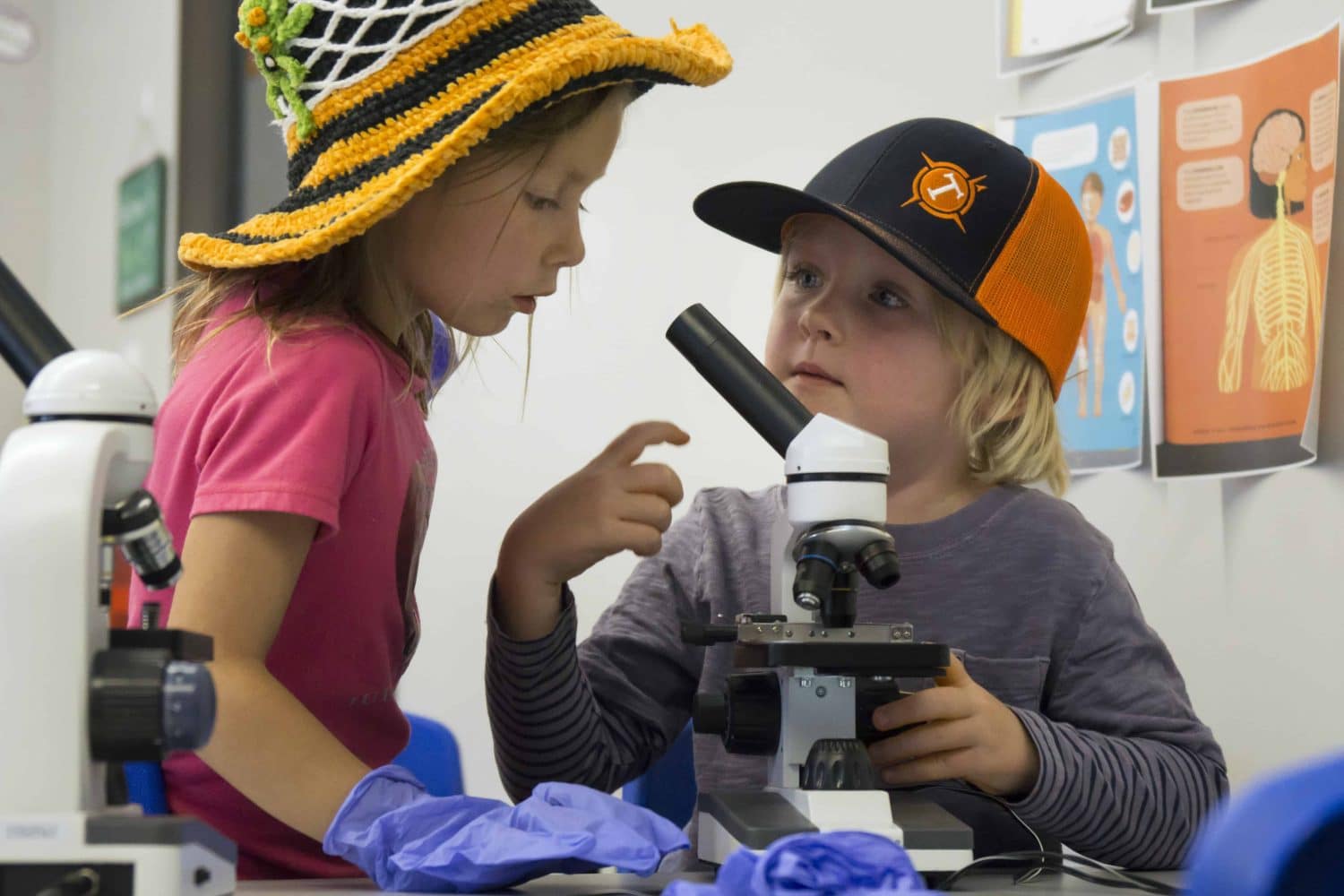 two pre-k students sharing a microscope