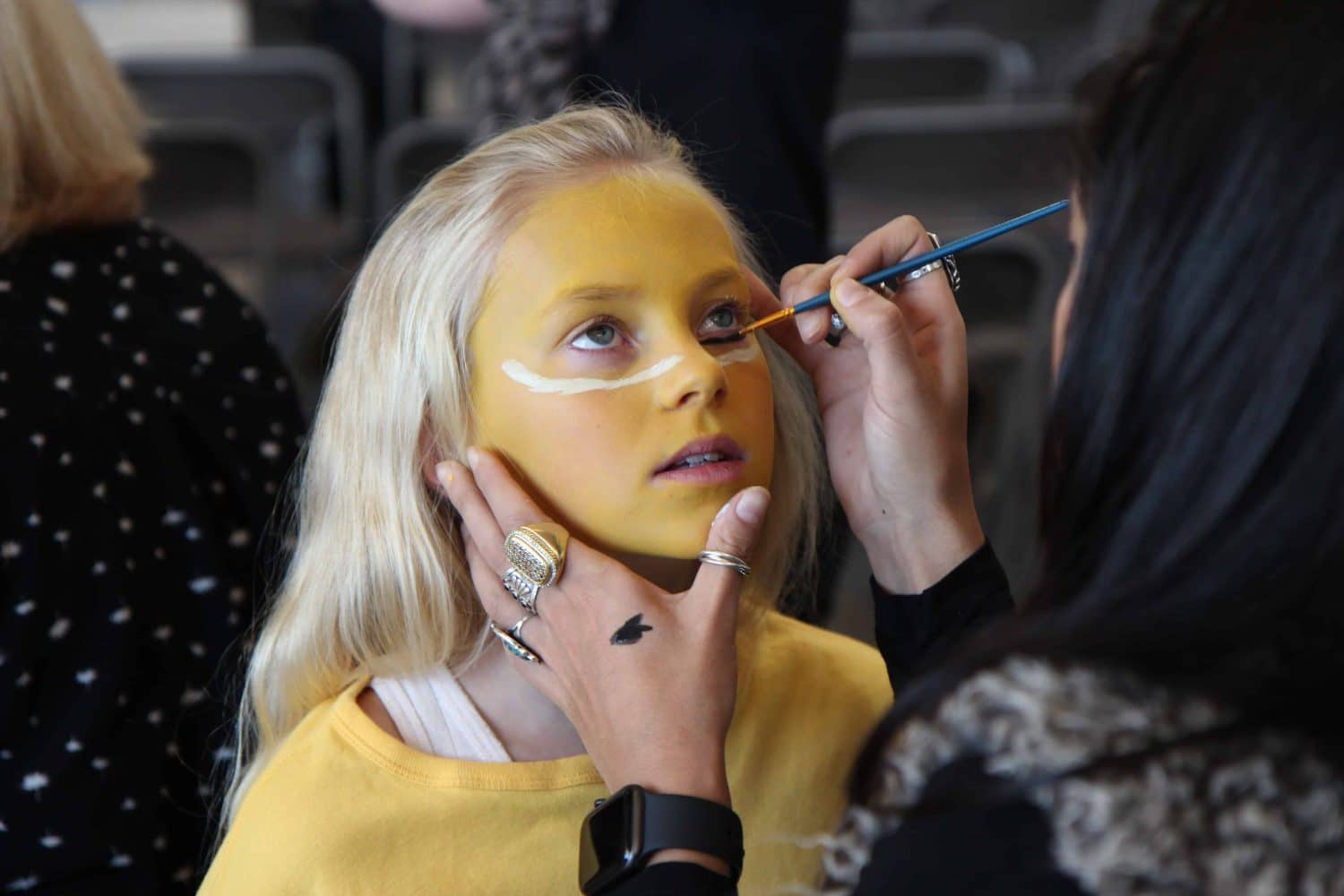 a girl having her stage makeup done