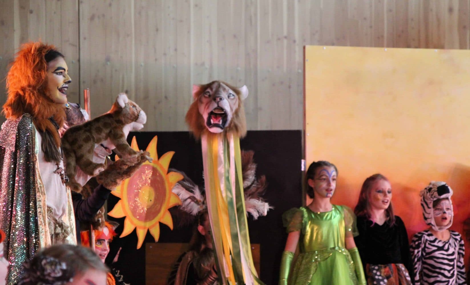 the drama club performing the lion king onstage